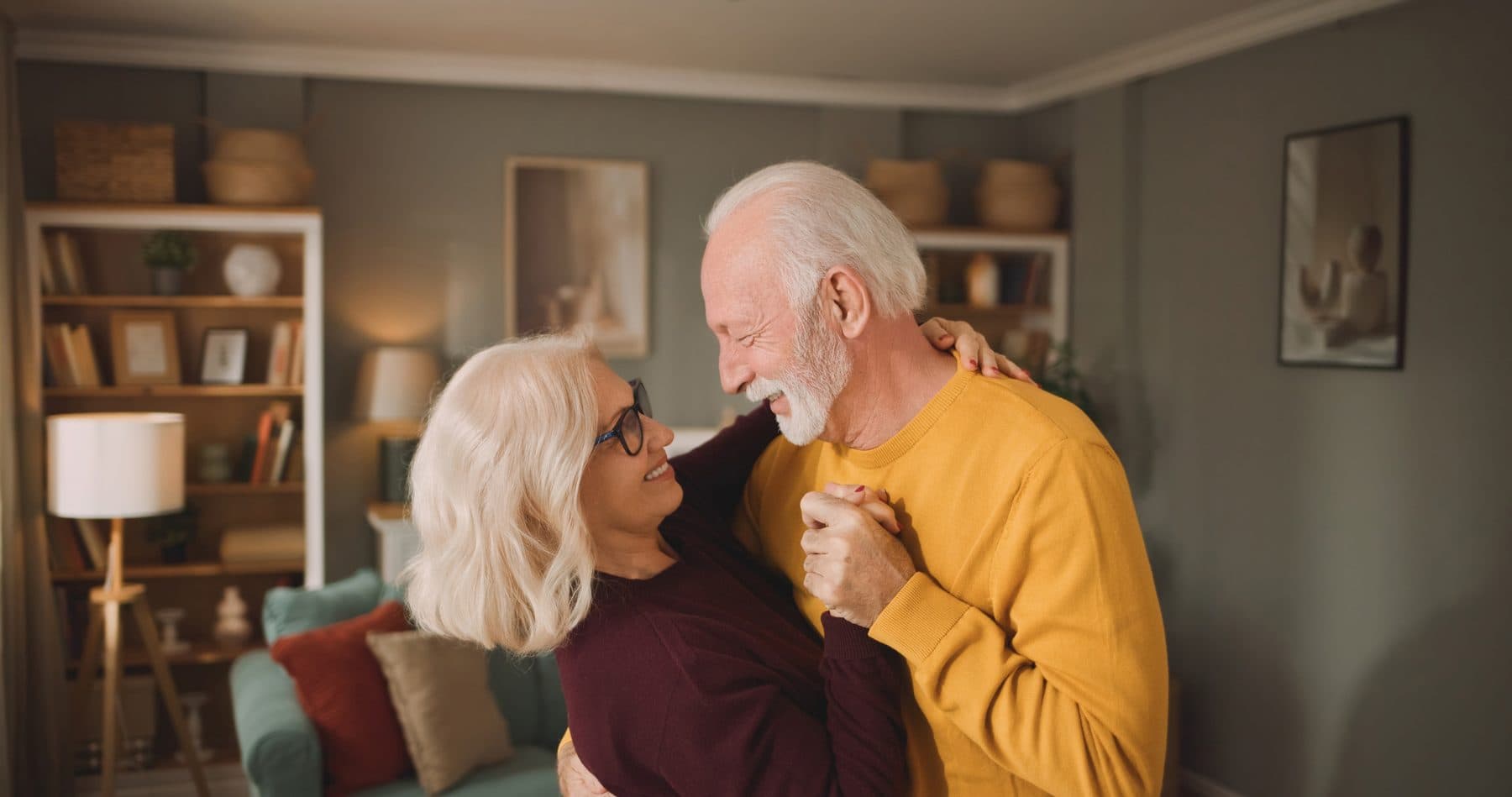 Older couple dancing together at home