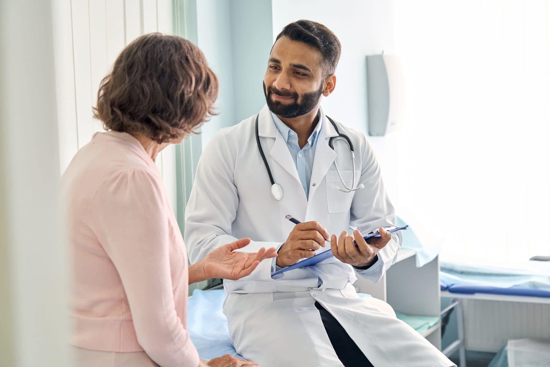 Clinician talking a member through their options in an exam room