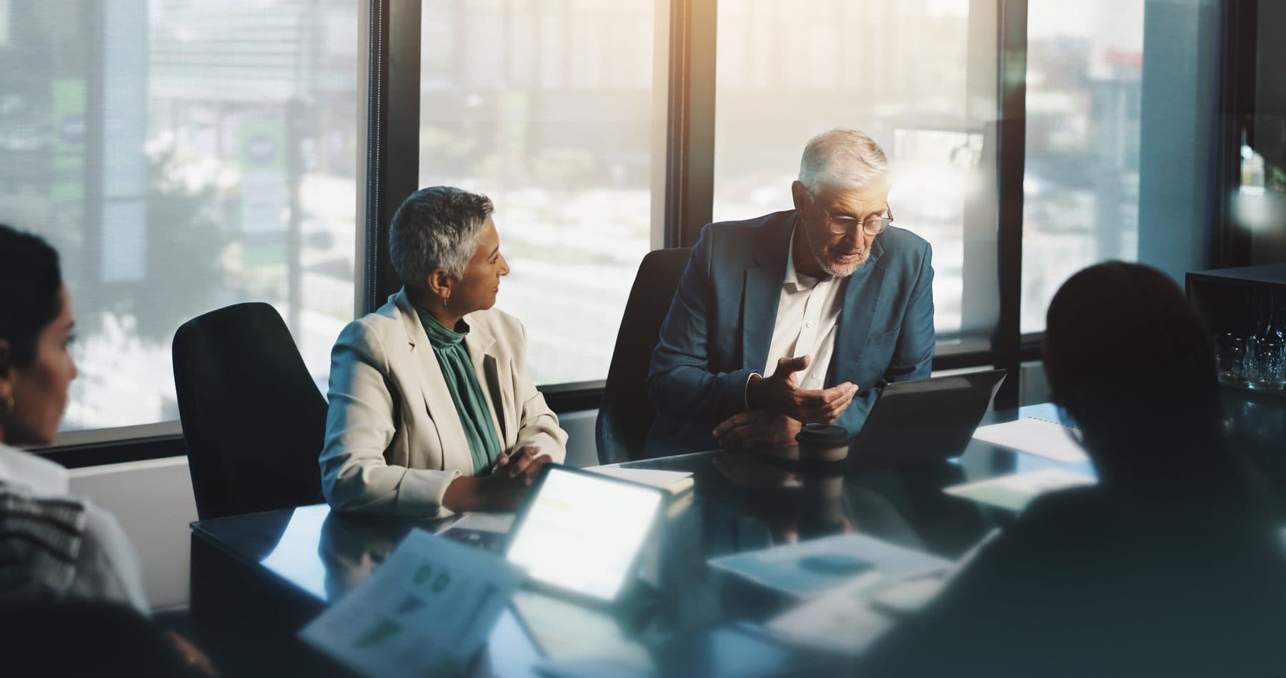 Leaders reviewing program options around a boardroom table