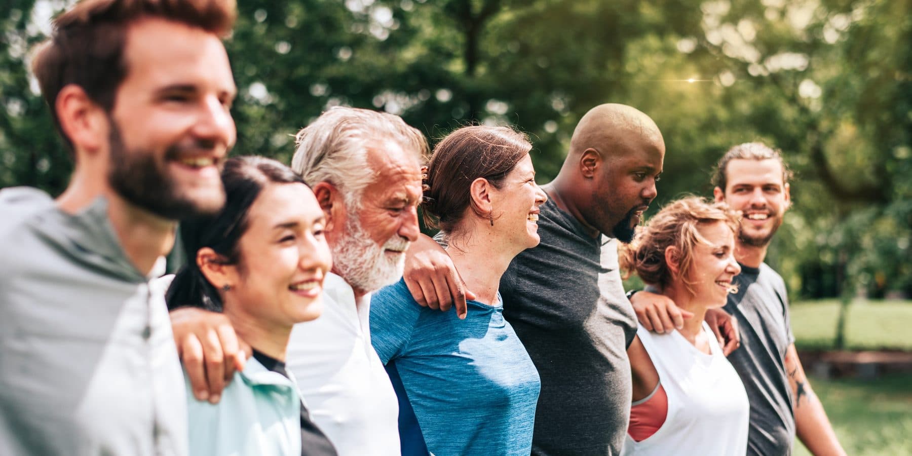 Group of people of different ages standing together outdoors